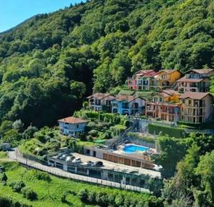 a group of houses on a hill next to a mountain at Perla di Lago Maggiore in Oggebbio