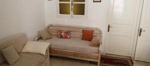 a room with a couch and a window and a door at Dar Cherif in Kasbah