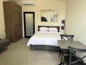 a bedroom with a bed and a table and chairs at טריו בכרמל in Dāliyat el Karmil +22 photos