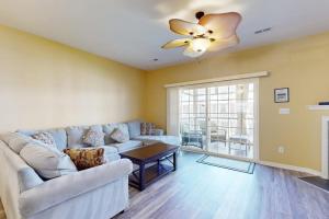 a living room with a couch and a ceiling fan at Rehoboth Crossing 19915 Ames Dr in Rehoboth Beach
