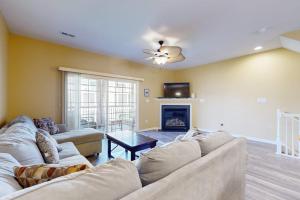 a living room with a couch and a fireplace at Rehoboth Crossing 19915 Ames Dr in Rehoboth Beach