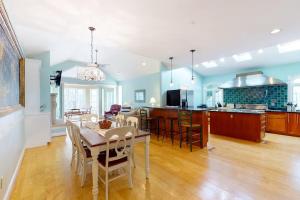 a kitchen and living room with a table and chairs at Salt Pond -- 273 Oyster Shell Cove in Bethany Beach