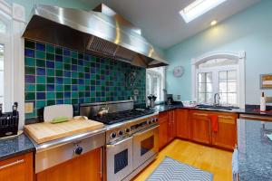 a large kitchen with a stove and a sink at Salt Pond -- 273 Oyster Shell Cove in Bethany Beach