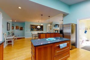 a kitchen with a counter top and a refrigerator at Salt Pond -- 273 Oyster Shell Cove in Bethany Beach