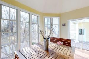 a living room with a wooden table and windows at Salt Pond -- 273 Oyster Shell Cove in Bethany Beach +43 photos