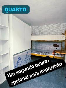 a room with a bed and a sign on the floor at Condomínio top in São Paulo