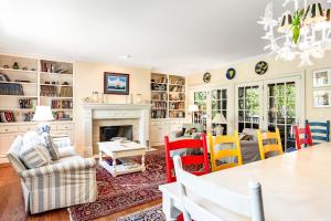 a living room with a fireplace and a table and chairs at Rehoboth Beach --- 6 Holly Road in Rehoboth Beach