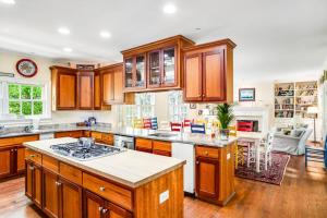 a kitchen with wooden cabinets and a stove top oven at Rehoboth Beach --- 6 Holly Road in Rehoboth Beach