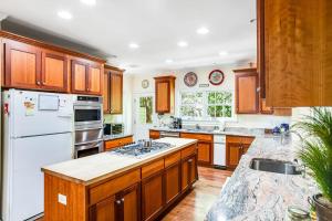 a kitchen with wooden cabinets and a white refrigerator at Rehoboth Beach --- 6 Holly Road in Rehoboth Beach +49 photos
