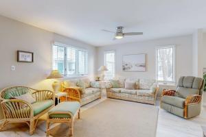 a living room with couches and chairs and windows at Bethany Pines --- 428 Bethany Pines in Bethany Beach