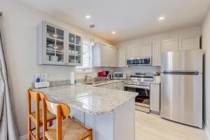 a kitchen with white cabinets and a stainless steel refrigerator at Bethany Pines --- 428 Bethany Pines in Bethany Beach