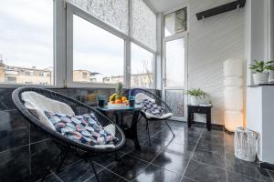 a balcony with two chairs and a table at Selection Rooms in Belgrade