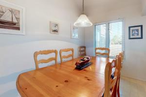 a dining room with a wooden table and chairs at Stewards Watch -- 539C Hudson in Bethany Beach