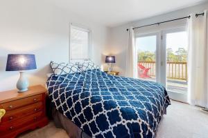 a bedroom with a bed and a dresser and a window at Stewards Watch -- 539C Hudson in Bethany Beach +14 photos