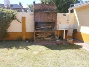 a brick wall with a brick oven in a yard at Casa Miramar Costa Atlantica Rep Argentina in Miramar