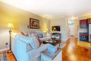 a living room with a white couch and a table at The Tides --- 19979 Sandy Bottom Circle, Unit #504 in Rehoboth Beach