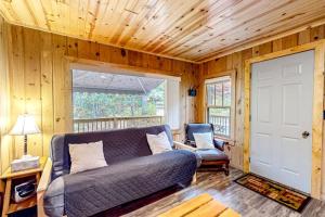 a living room with a couch and a chair at Dragonfly Gully in Rhinelander