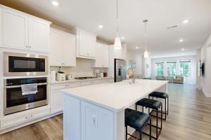 a kitchen with white cabinets and a white counter top at The Peninsula --- 22198 Dune Cir in Millsboro