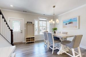 a dining room with a table and chairs at The Peninsula --- 22198 Dune Cir in Millsboro