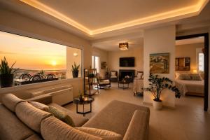 a living room with a couch and a bed at Endless View Villa with Private Pool & BBQ in Daratso