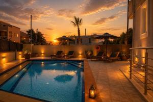 a swimming pool with a sunset in the background at Endless View Villa with Private Pool & BBQ in Daratso