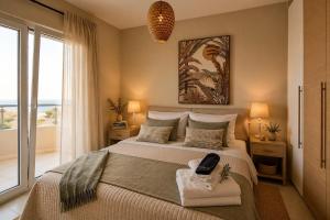 a bedroom with a large bed with a large window at Endless View Villa with Private Pool & BBQ in Daratso +45 photos