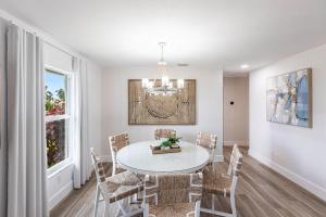 a dining room with a white table and chairs at Vanessas Villa in Marco Island +41 photos