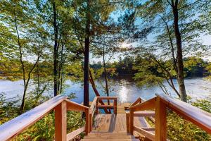 a wooden bridge over a body of water at Brown Bear Cabin in Tomahawk