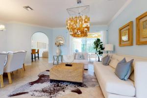 a living room with a white couch and a chandelier at Villa Katrin in Naples