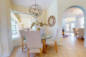 a dining room with a glass table and chairs at Villa Katrin in Naples