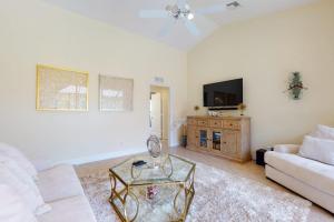 a living room with a white couch and a tv at Villa Katrin in Naples +24 photos