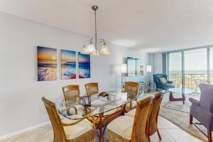 a dining room with a glass table and chairs at Seaview Sunsets in Marco Island