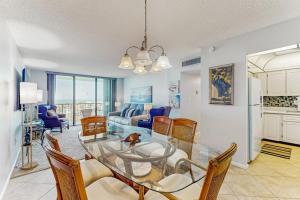 a dining room and living room with a glass table and chairs at Seaview Sunsets in Marco Island