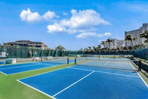 a tennis court with two tennis courts at The Breezy Perch in Marco Island