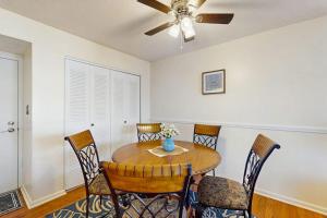 a dining room table with chairs and a ceiling fan at The Breezy Perch in Marco Island