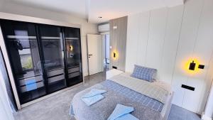 a bedroom with a bed and a large window at Villa Maris Belek Villa in Belek +53 photos