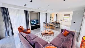 a living room with a large couch and a table at Villa Maris Belek Villa in Belek