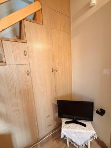 a room with wooden cabinets with a computer on a table at Villa Elena ΝΕΑΠΟΛΗ ΒΟΙΩΝ in Áyioi Apóstoloi