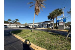 a shadow of a person standing next to a street at Regency Inn Daytona Beach Near Airport in Daytona Beach