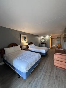 a hotel room with two beds and a desk at Ocean 12 Beach Hotel in Myrtle Beach
