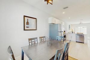 a kitchen and dining room with a wooden table and chairs at Sunny Shores- Sunrise in Englewood
