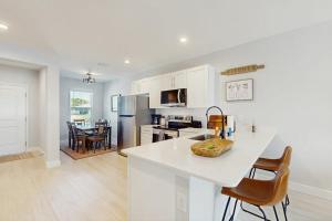 a kitchen with white cabinets and a counter top at Sunny Shores- Sunrise in Englewood