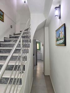 a staircase in a home with a white stair case at Mastiha Essence Residence in Pyrgi