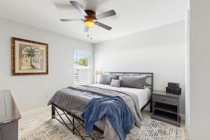 a bedroom with a bed and a ceiling fan at Sunny Shores- Sunrise in Englewood +10 photos