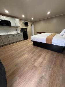 a large room with a bed and a kitchen at AC Suites in Atlantic City