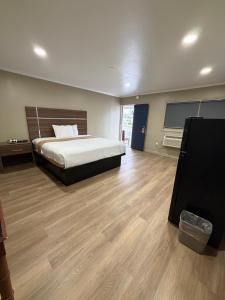 a bedroom with a bed and a wooden floor at AC Suites in Atlantic City