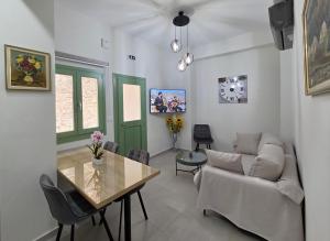 a living room with a couch and a table at Mastiha Essence Residence in Pyrgi