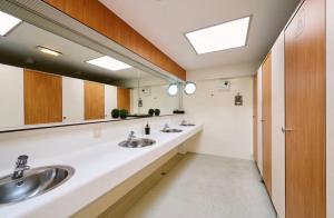 a bathroom with two sinks and a large mirror at Glamping Houseboat in Dinteloord +14 photos