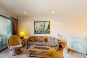 a living room with a couch and a chair at Sea Colony - 1004D Brighton Vw in Bethany Beach