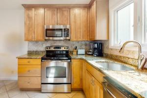 a kitchen with a stove and a microwave at Sea Colony - 1004D Brighton Vw in Bethany Beach +38 photos